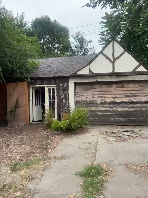 Glenhurst Avenue rear structure before construction — deteriorated garage and overgrown driveway